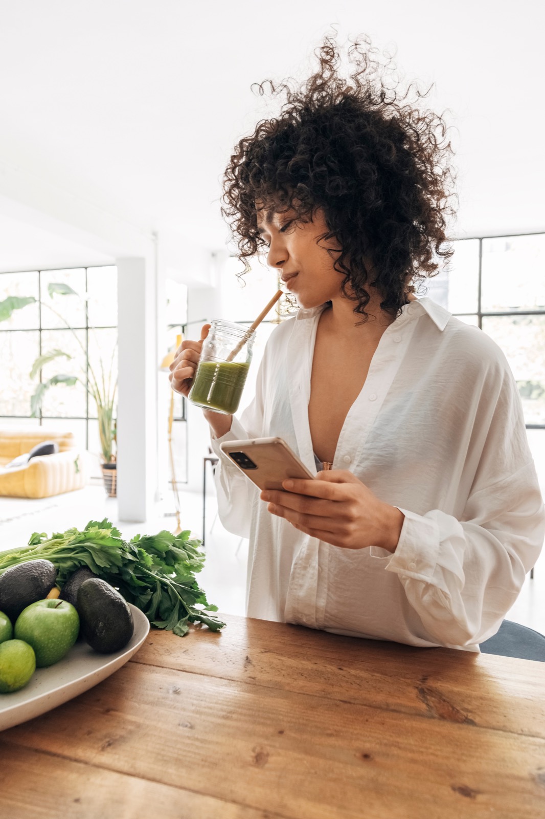 Person enjoying a green wellness drink